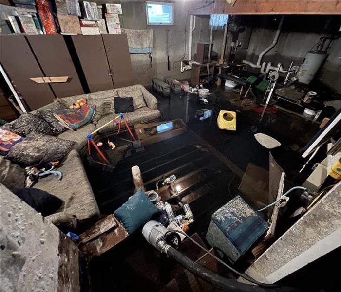 a basement with flooded water and mold