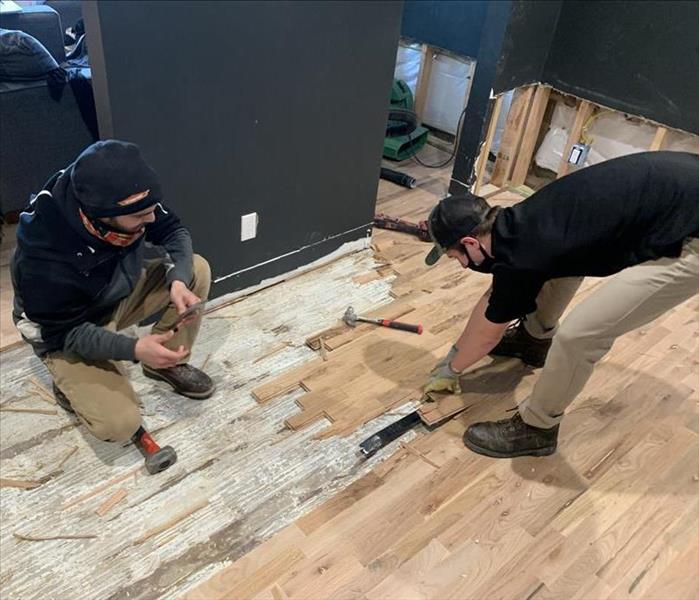 SERVPRO workers removing floor